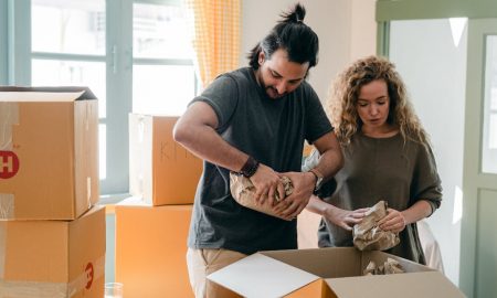 Moving hacks - Couple packing belongings in boxes.